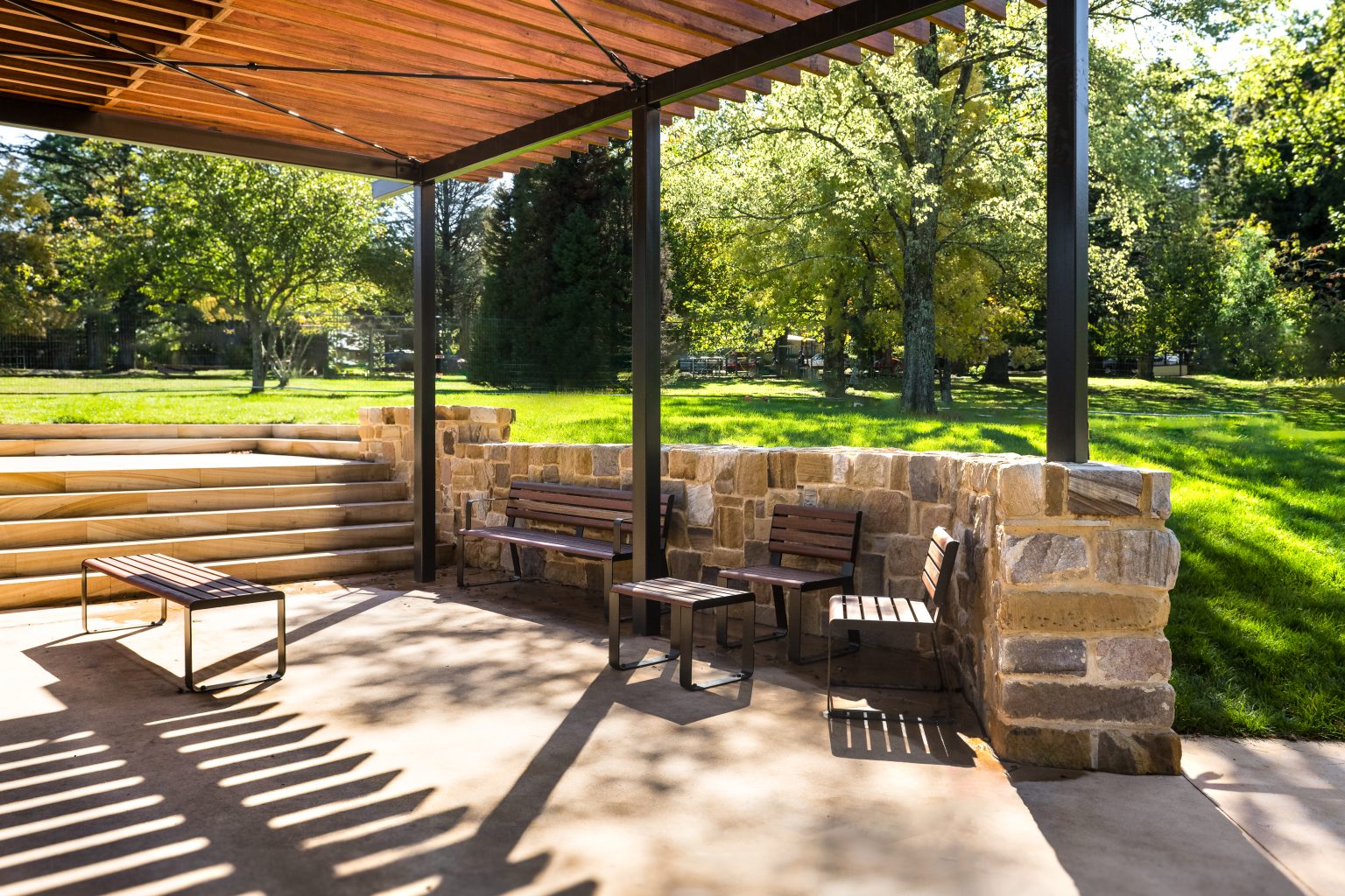 Linea Bench (LIB6) and Linea Seat (LIS10) with Spotted Gum hardwood battens, Textura Dark Bronze frame.