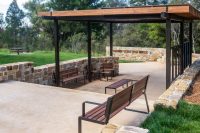 Linea Seat (LIS10) and Linea Bench (LIB6) with Spotted Gum hardwood battens, Textura Dark Bronze frame.