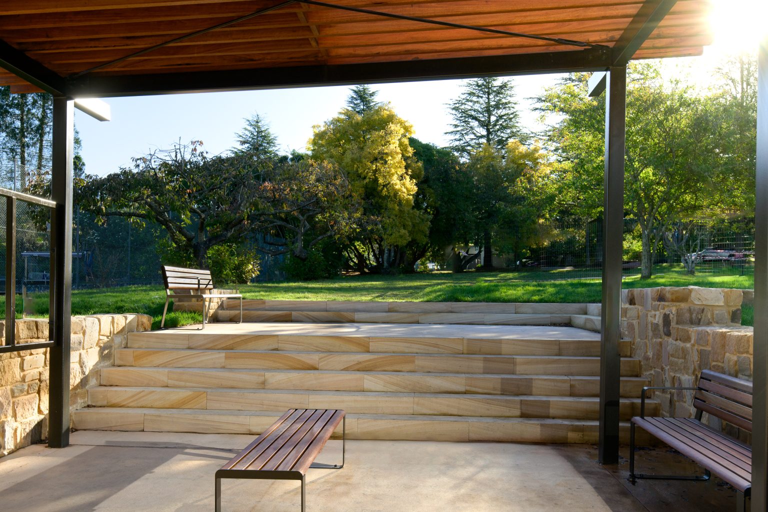 Linea Bench (LIB6) and Linea Seat (LIS10) with Spotted Gum hardwood battens, Textura Dark Bronze frame.