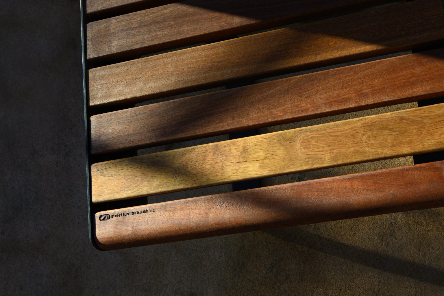 Linea Seat (LIS10) detail with Spotted Gum hardwood battens, Textura Dark Bronze frame.