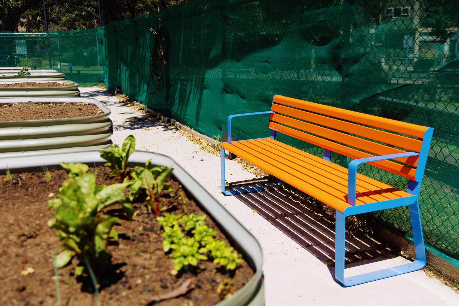 Linea Seat (LIS10 1800mm), freestanding with Bondi Blue frame and Sensation Orange battens