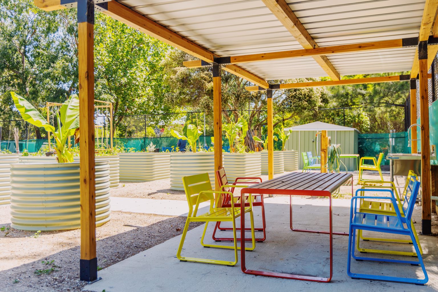 Piatto Chairs in Brilliant Yellow, Lobster Red and Bondi Blue. Linea Table in Lobster Red frame with aluminium woodgrain battens in Spotted Gum