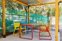 Piatto Chairs in Brilliant Yellow, Bondi Blue and Lobster Red. Linea Table in Lobster Red frame with aluminium woodgrain battens in Spotted Gum