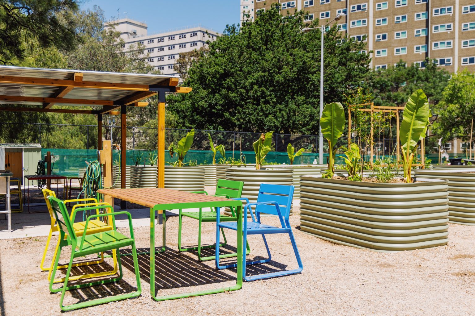 Piatto Chairs with aluminium battens in Viper Green, Brilliant Yellow and Bondi Blue. Linea Table in Viper Green frame with aluminium woodgrain battens in Spotted Gum