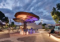 Aria Seat (CMA1), plinth-fixed. Eco-certified hardwood battens, Textura Woodland Grey frames. Hovering Earth Canopy by iredale pederson hook