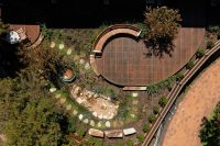 Aerial view of garden with Linea Curved Seats in Textura Surfmist, Wood Without Worry battens in Spotted Gum.