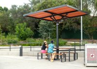 ChillOUT Tree (CT1) powered, in Satin Monument with custom roof colour (Red Dust). Linea Table (LIT10-DDA) and Linea Bench (LIB6) in aluminium woodgrain Spotted Gum battens and Textura Monument frame.