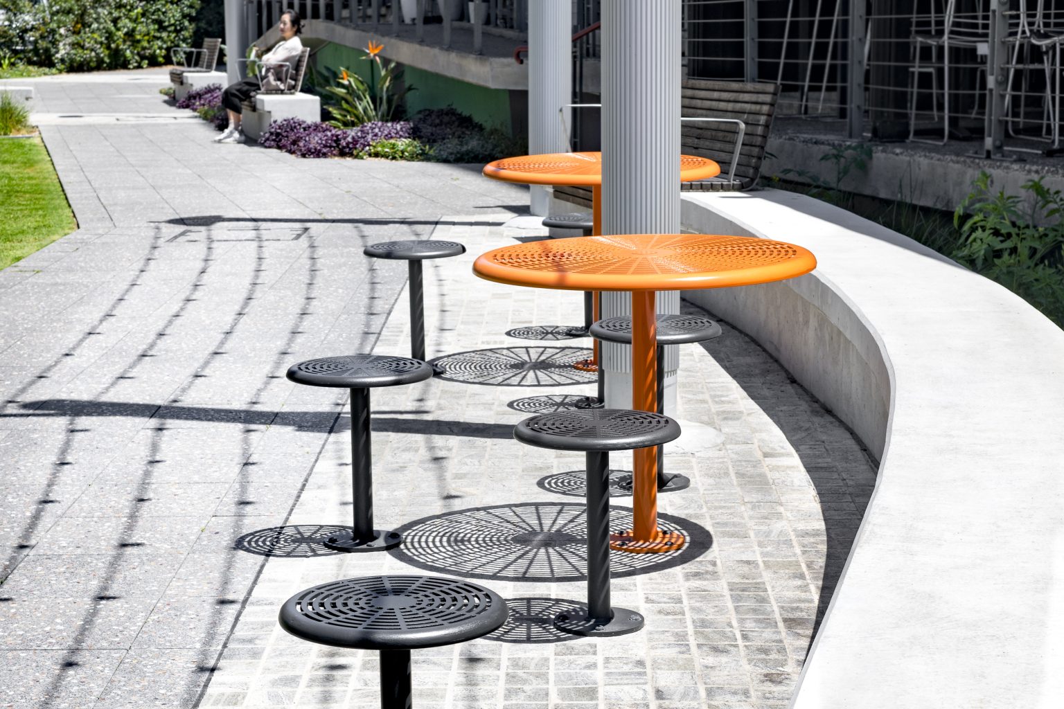 Cafe Tables in Bistro Orange Gloss with Cafe Stools in Textura Monument.