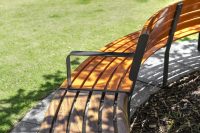 Curved Linea Seat and Bench with frame in Textura Monument and battens in Bistro Orange and aluminium woodgrain Spotted Gum.
