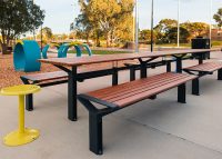 Aria Long Communal Table (CMA6-L) with aluminium Spotted Gum battens, Textura Monument frames.