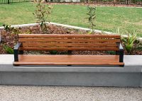 Linea Seat (LIS10) 1800mm with aluminium woodgrain Spotted Gum battens, Monument frame, plinth-fixed.