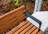 Linea Seat (LIS10) 1800mm with aluminium woodgrain Spotted Gum battens, Monument frame, plinth-fixed.