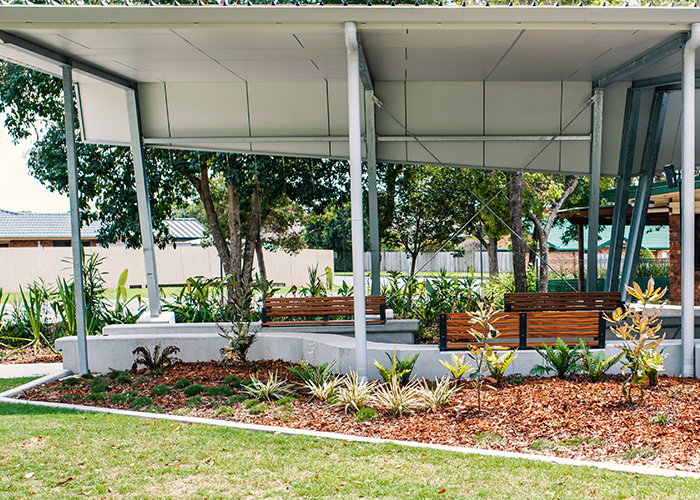Linea Seat (LIS10) 1800mm with aluminium woodgrain Spotted Gum battens, Monument frame, plinth-fixed.