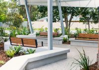 Linea Seat (LIS10) 1800mm with aluminium woodgrain Spotted Gum battens, Monument frame, plinth-fixed.