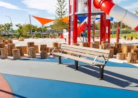 Park DDA Seat, aluminium woodgrain battens in Beach Oak, frames in Woodland Grey.