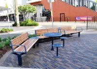 Aria Curved, Cafe Table and Stools, with aluminium woodgrain Spotted Gum battens and Deep Ocean frames.