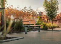 Aria Seat (CMA1) with Pedestal leg, aluminium woodgrain Spotted Gum battens, Sable Brilliance frame.