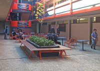 Mall Mitred Bench and Forum Seats in Woodgrain Aluminium Bush Cherry, with Cafe Round Table.