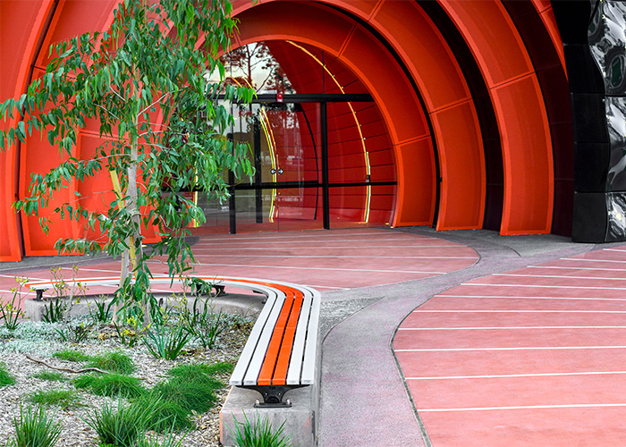 Mall Slim Bench, curved (CMM8-C) and straight (CMM8) plinth-fixed with Textura Silver and Sensation Orange battens, Charcoal frame.