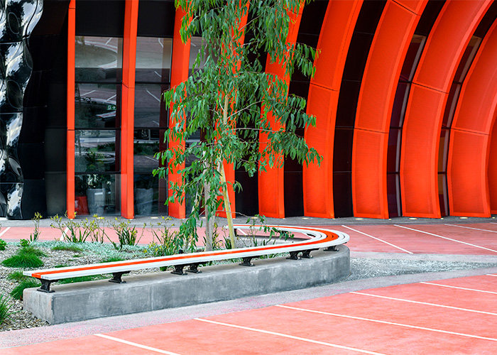 Mall Slim Bench, curved (CMM8-C) and straight (CMM8) plinth-fixed with Textura Silver and Sensation Orange battens, Charcoal frame.