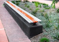 Mall Slim Bench (CMM8) plinth-fixed with Textura Silver and Sensation Orange battens, Charcoal frame.