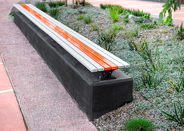 Mall Slim Bench (CMM8) plinth-fixed with Textura Silver and Sensation Orange battens, Charcoal frame.