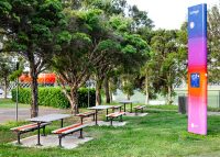 Mall Setting (CMM6) with Slim Benches (CMM8), Textura Silver and Sensation Orange battens, Charcoal frame.