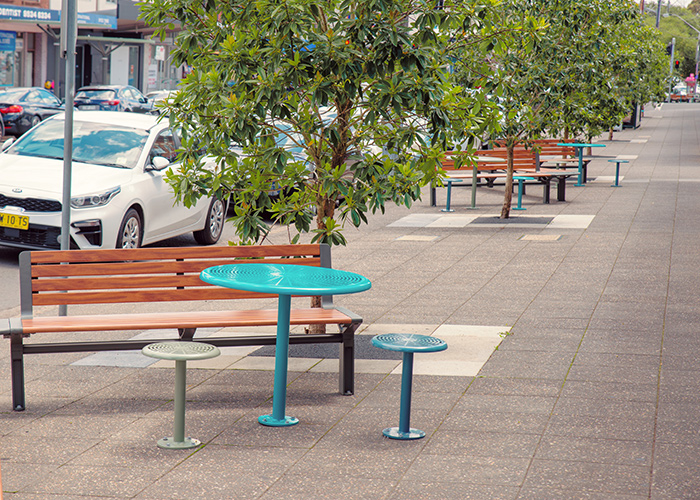 Aria Seating System (3S-C90-3B-C90-3S) with aluminium Spotted Gum battens and Textura Woodland Grey frame. Cafe Settings in tailored colour Deep Pool, Wizard and Pale Eucalypt Green.