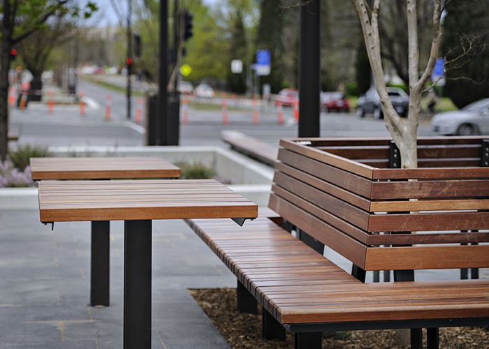 Custom seats and tables with brass detailing. Randal Photography.