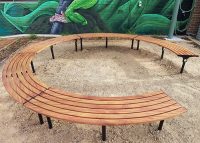 Mall Curved Benches, battens in aluminium woodgrain Spotted Gum, frames in Night Sky.