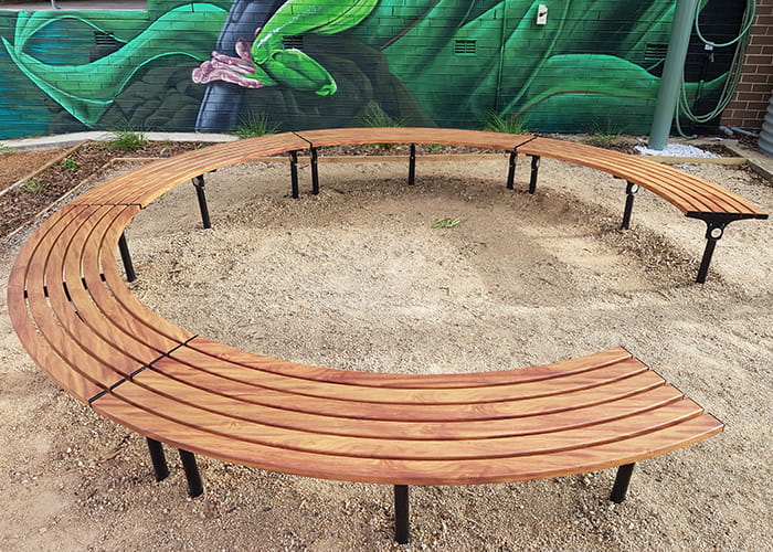 Mall Curved Benches, battens in aluminium woodgrain Spotted Gum, frames in Night Sky.