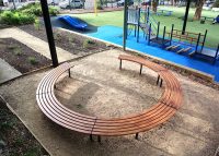 Mall Curved Slim Benches, battens in aluminium woodgrain Spotted Gum, frames in Night Sky.