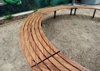 Mall Curved Slim Benches, battens in aluminium woodgrain Spotted Gum, frames in Night Sky.