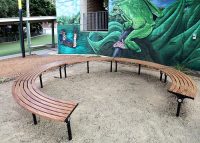 Mall Curved Slim Benches, battens in aluminium woodgrain Spotted Gum, frames in Night Sky.
