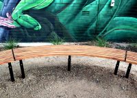 Mall Curved Slim Benches, battens in aluminium woodgrain Spotted Gum, frames in Night Sky.