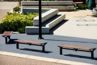 Aria Benches (CMA4) with battens in aluminium woodgrain Spotted Gum, Textura Woodland Grey frames.