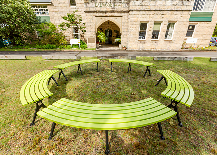 Mall Curved Slim Benches, powdercoated in Lycra Strip green with Night Sky frames.