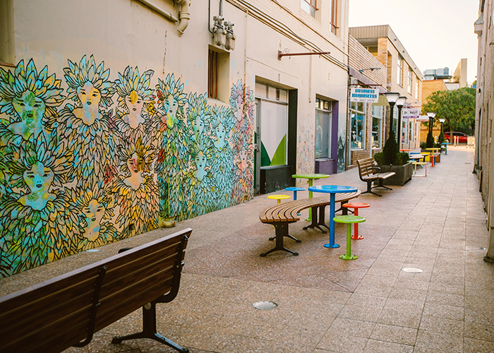 Mall Seat and Mall Curved Slim Bench with aluminium Spotted Gum battens, Textura Monument frame. With Cafe Macchiato Table and Stool in Brilliant Yellow, Bondi Blue, Sensation Orange and Lycra Strip Green.