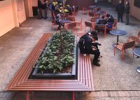 Mall Mitred Bench and Forum Seats in Woodgrain Aluminium Bush Cherry, with Cafe Round Table.