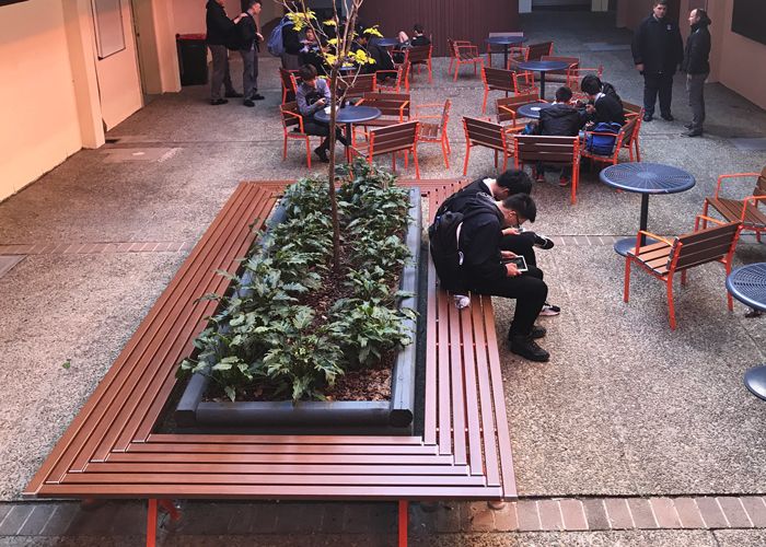 Mall Mitred Bench and Forum Seats in Woodgrain Aluminium Bush Cherry, with Cafe Round Table.