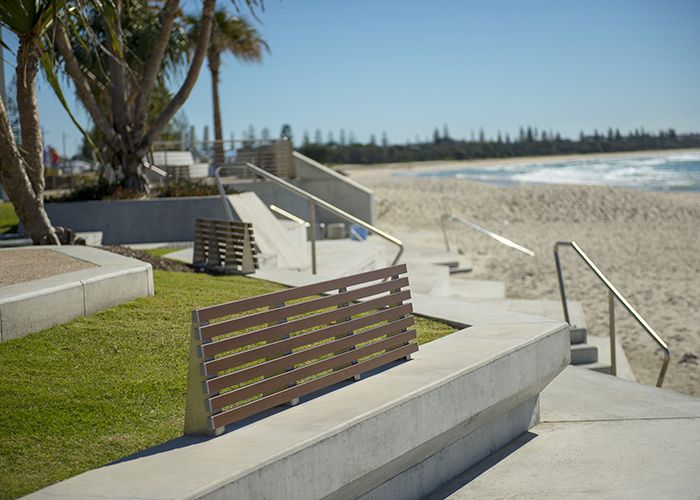 Custom seats on concrete plinths with aluminium woodgrain Woodland Grey battens.