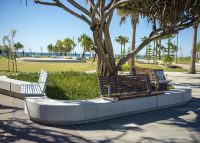 Custom seats on concrete plinths with aluminium woodgrain Woodland Grey battens.