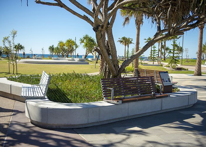 Custom seats on concrete plinths with aluminium woodgrain Woodland Grey battens.