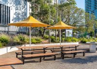 Aria Long Communal Table (CMA6-L, 5000mm) aluminium Spotted Gum battens, Textura Dark Bronze frame.