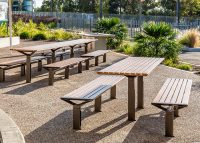 Aria DDA Setting and Long Communal Table with aluminium Spotted Gum battens, Textura Dark Bronze frame.