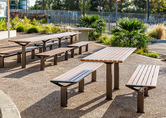 Aria DDA Setting and Long Communal Table with aluminium Spotted Gum battens, Textura Dark Bronze frame.