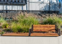 Aria Seating System (3S-3B) with aluminium Spotted Gum battens, Textura Dark Bronze frame.