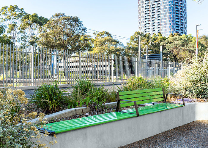 Aria Seating System (3S-3B) plinth-fixed with Viper Green battens, Textura Dark Bronze frame.