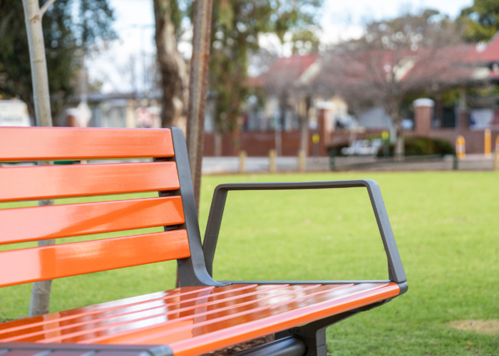 Aria Seating System with arm, Sensation Orange battens, Textura Woodland Grey frame.