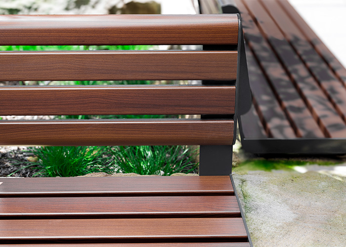 Linea Seat (LIS10, 1500mm) plinth-fixed with aluminium woodgrain Bush Cherry battens, Monument frame.